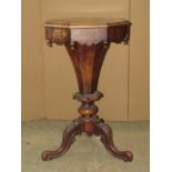 A Victorian walnut trumpet shaped work box of octagonal form with rising lid, over a segmented