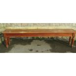 A Victorian mahogany hall bench of rectangular form raised on four turned and tapered supports,