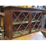 Georgian mahogany wall cabinet enclosed by a pair of astragal glazed panelled doors enclosing a