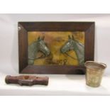 An early 20th century framed panel in relief showing two mares with metallic finish, within a