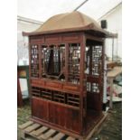 A Chinese stained pine framed box seat, the panelled frame with lattice detail beneath a pagoda