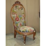 A large Victorian open drawing room chair with carved and moulded show wood frame, hand worked