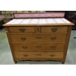 A late 19th century oak chest of three long and two short drawers, the top inset with original art