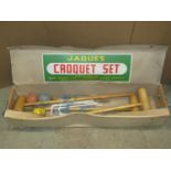 A Jaques croquet set housed within its original cardboard and pine box containing three mallets,