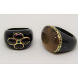 Two unusual Eastern style hardstone rings with gold detail; one set with a cluster of garnets (2)