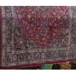 A large Mashan full pile carpet, with various typical scrolled foliate Islamic decoration upon red