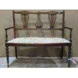 An inlaid Edwardian lightweight two seat parlour sofa, with pierced vase shaped splats over an