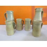 Dorothy Kemp studio pottery celadon glaze pitcher and tankard set, together with a further jug (6)