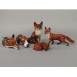 A Beswick model of a recumbent fox, a Beswick model of a running fox, a pair of Royale Stratford