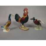 A collection of three Beswick models of birds comprising a leghorn cockerel impressed numbers to