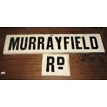 A vintage white glazed ceramic two piece tile sign with black lettering advertising Murray Field