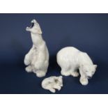 A family of three Royal Copenhagen polar bears comprising a seated example roaring, no 502, 33cm