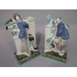 A pair of Rye pottery flat back figures of Edwardian style male and female golfers, with printed