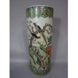 An oriental vase or stick stand of cylindrical form with polychrome painted decoration of