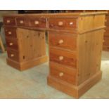 A stripped pine kneehole twin pedestal dressing table/desk in the Victorian style, fitted with an