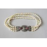Triple strand cultured pearl bracelet, the associated Art Deco white metal clasp set with rose cut