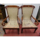 a pair of mahogany elbow chairs in a colonial/regency style with cane panels seat and back, with
