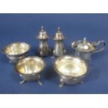 A collection of silver cruet items comprising a pair of baluster peppers, a pair of salts with