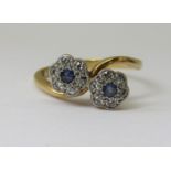 18ct daisy crossover ring set with sapphires and diamonds, size K/L, 3.2g