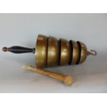 A 19th century hand held tower of five graduated bells, with turned and ribbed ebony handle, with