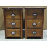 A pair of low three drawer pedestal chests of sleeper wood construction, 61 cm high x 38 cm wide x
