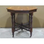 An Edwardian walnut occasional table of octagonal form, raised on turned supports, united by an X
