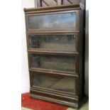 A Globe Wernicke & Co Ltd floorstanding four sectional library bookcase enclosed by rectangular up