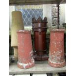 A Victorian salt glazed crown top chimney pot together with a buff coloured conical shaped example