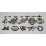 Collection of ten silver / white metal brooches to include two polished agate examples, antique