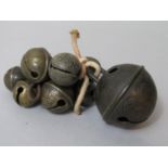 A collection of crotal bells of various sizes (10), the largest 6.5 cm diameter by Robert Wells