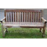 A weathered teak three seat garden bench with slated seat and back, 5ft long