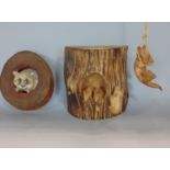 Three timber mice emerging from a tree stump, a carved wood cat climbing a rope and a cat peeping