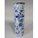 A 19th century oriental vase of cylindrical form with blue and white painted decoration of figures