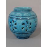 A early 20th century Burmantoft Faience vase with pierced detail and turquoise glaze, with incised