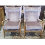 A pair of vintage Parker Knoll type open armchairs with upholstered wing back, loose seat