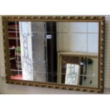 Two contemporary gilt framed wall mirrors of varying size and design with moulded frames and foliate