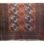 Full pile Bokhara carpet with typical geometric medallion decoration upon a burnt orange ground, 210