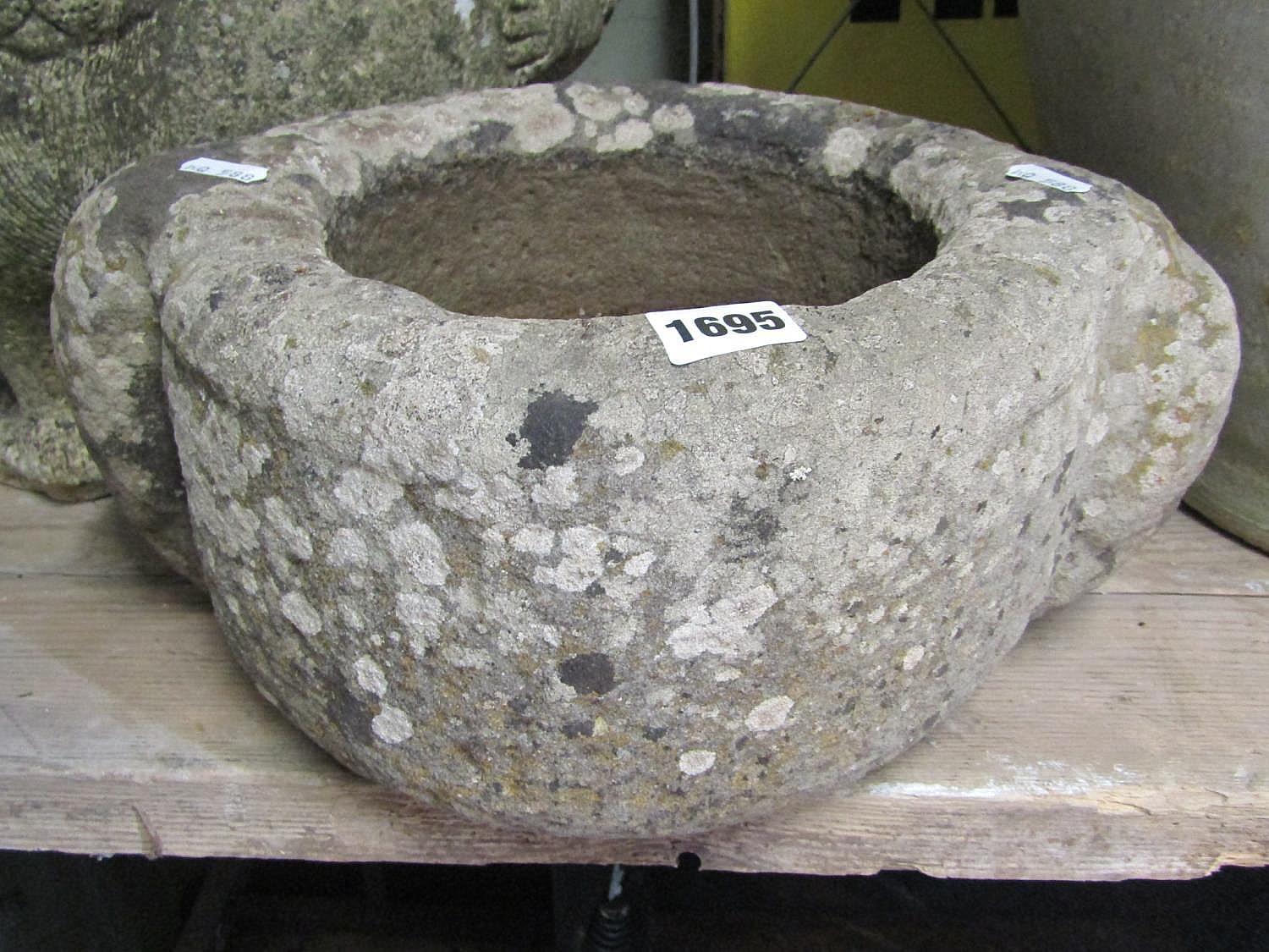 An old, possibly ancient, carved stone mortar with lug handles, 28 cm in diameter (excluding