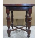 An unusually small oak draw-leaf dining table, raised on turned baluster supports united by a X
