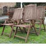 A set of four Ferman contemporary teak folding garden armchairs with slatted seats and backs