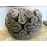 A weathered natural stone corbel with deep carved scrolling foliate detail, 38 cm in diameter approx