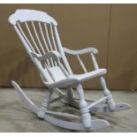A Boston type child's stick-back rocking chair, with shaped arms, solid seat and turned supports,