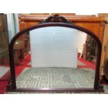 A contemporary but Victorian style overmantel mirror with moulded arch frame and scrolling