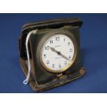 Tiffany & Co eight day folding travel clock within a leather case, the 4 cm enamel dial with