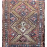 Antique Persian two medallion lori type rug, with pink, blue and washed red medallions upon a fawn