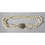 Double strand pearl necklace with associated antique rose cut diamond set circular clasp, in