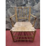 A 19th century ashwood elbow chair with turned mouldings and rush seat