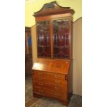 An inlaid Edwardian mahogany bureau bookcase of four long drawers, the fall flap with urn and swag