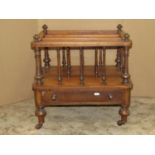 A Victorian walnut three divisional Canterbury with turned spindles, frieze drawer and further