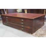 A vintage mahogany plan chest, fitted with four long drawers, with brass cup handles, flanked by